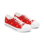 Red patterned sneakers with white soles on a white background