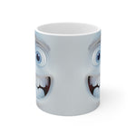Mug with cartoonish face design featuring eyes and mouth on a white background