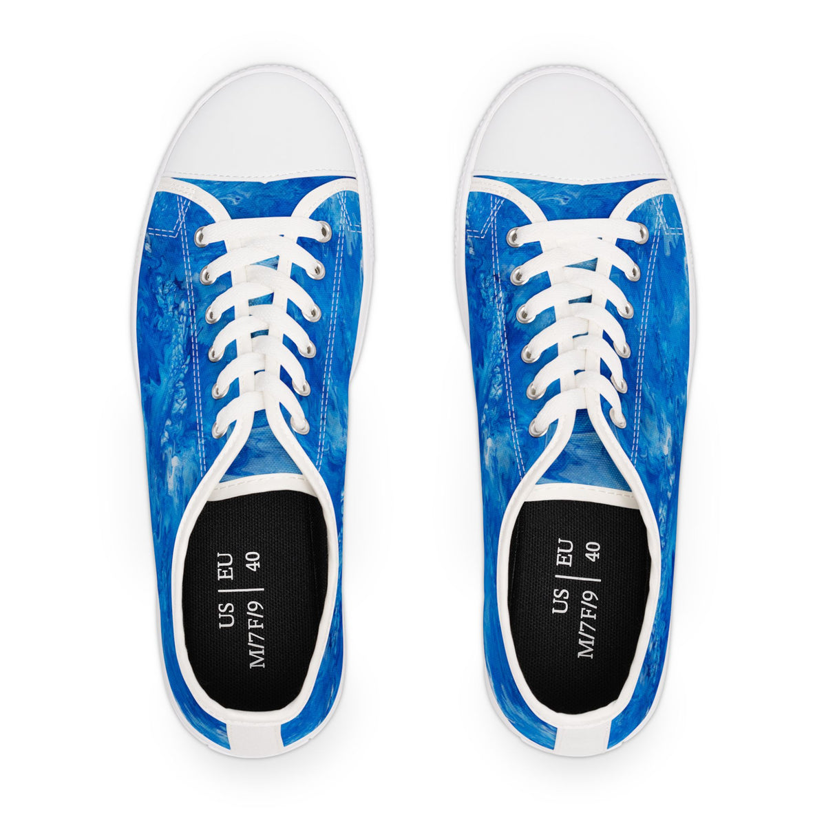 Pair of blue sneakers with white laces on a white background