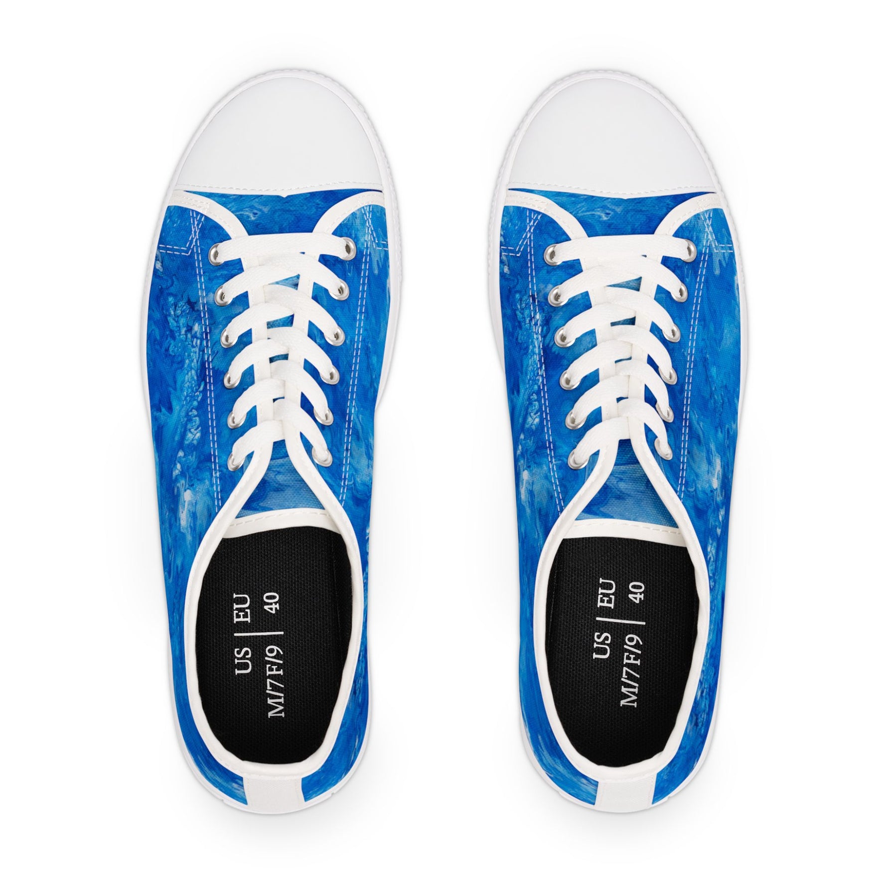 Pair of blue sneakers with white laces on a white background