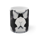 A white mug with a black cat design on a white background