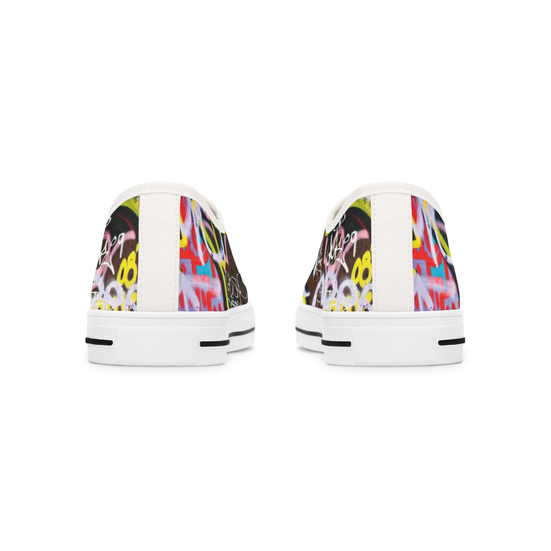 Pair of womens white sneakers with colorful graffity design on a white background