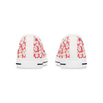 Pair of white sneakers with pink floral pattern on a white background