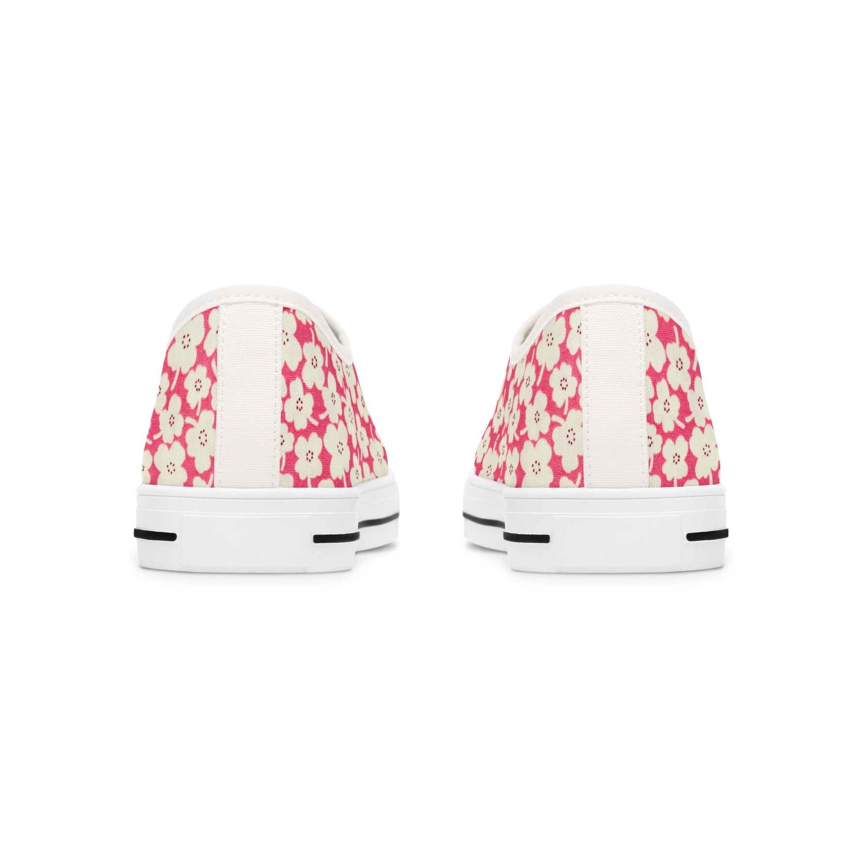 Pair of white sneakers with pink floral pattern on a white background
