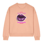 Stanley/Stella women's peach sweatshirt with purple lips graphic and text on a white background