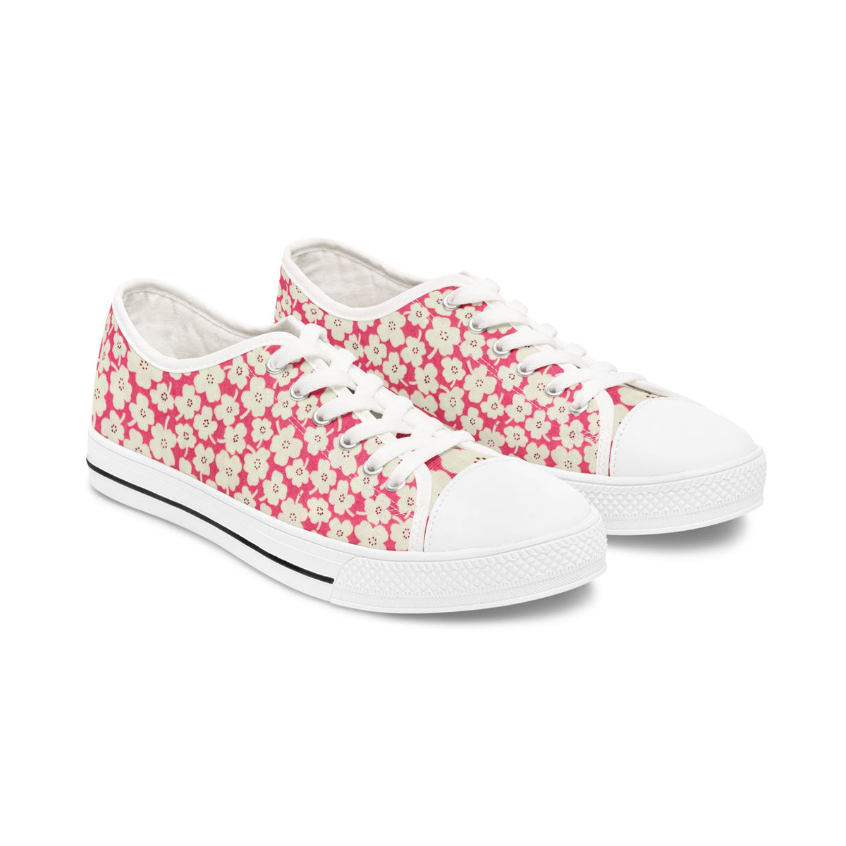 Pair of pink floral canvas sneakers on a white background