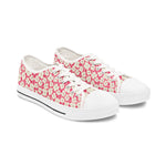 Pair of pink floral canvas sneakers on a white background