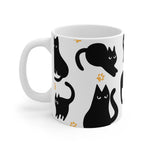 White mug with black cat illustrations on a white background
