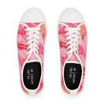 Pair of sneakers with pink and orange abstract pattern on a white background