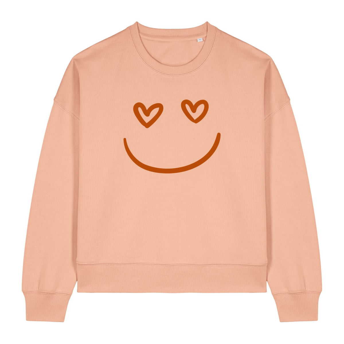 Stanley/Stella Peach-colored sweatshirt with a smiley face design featuring heart eyes on a white background