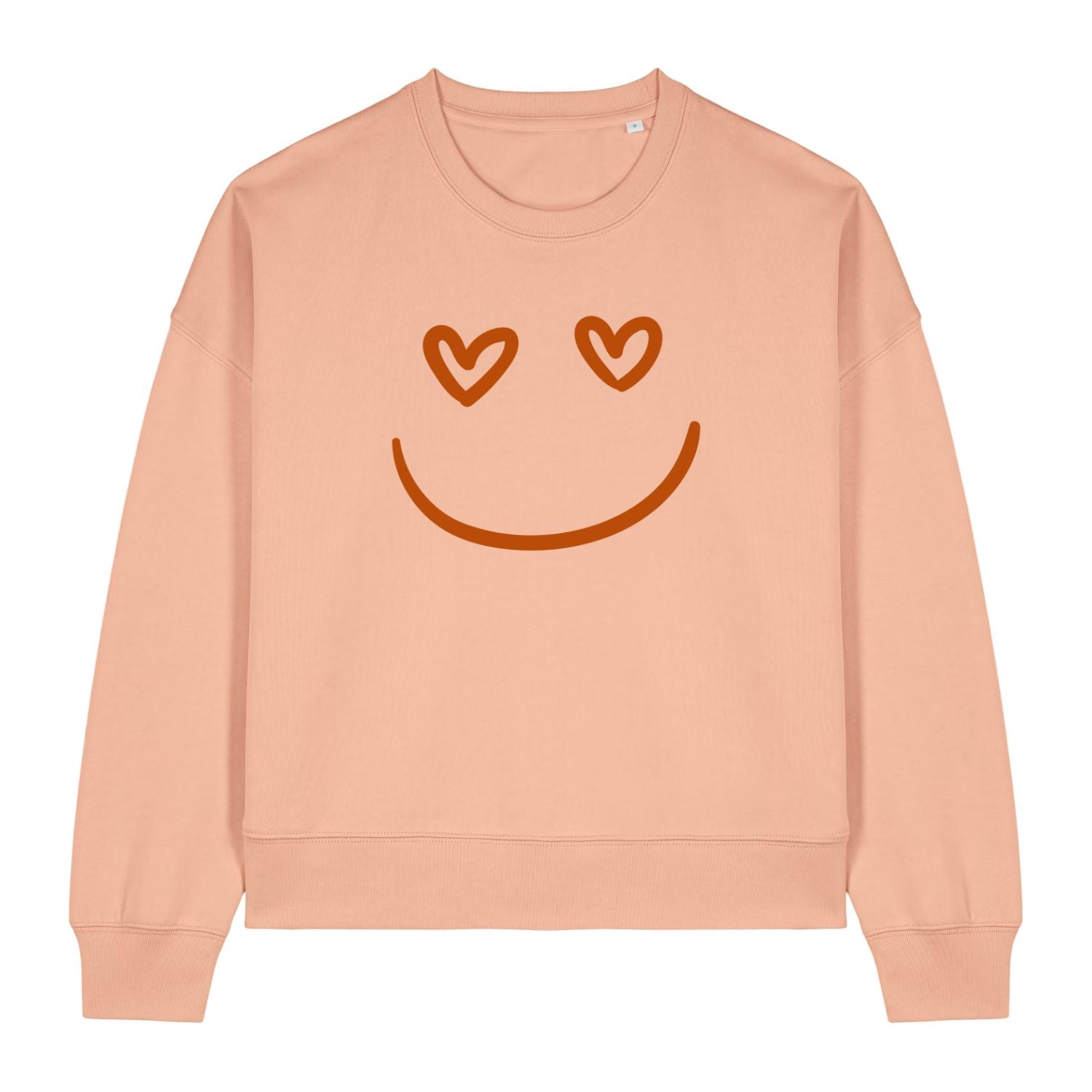 Stanley/Stella Peach-colored sweatshirt with a smiley face design featuring heart eyes on a white background