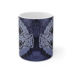 Ceramic mug with Celtic cross design on a white background