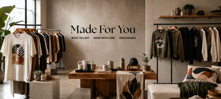 A styled retail interior with clothing racks, a wooden table, and a wall reading 'Made For You' with smaller text 'Built to Last. Made with Care.