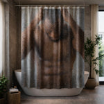 A bathroom with a modern white bathtub and plants features a shower curtain printed with a blurred image of a shirtless man standing behind wet, steamy glass, hands on his head. Natural light filters through large windows.