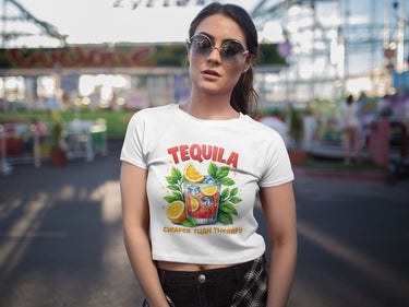Woman wearing a 'Tequila Cheaper Than Therapy' t-shirt at an outdoor event.