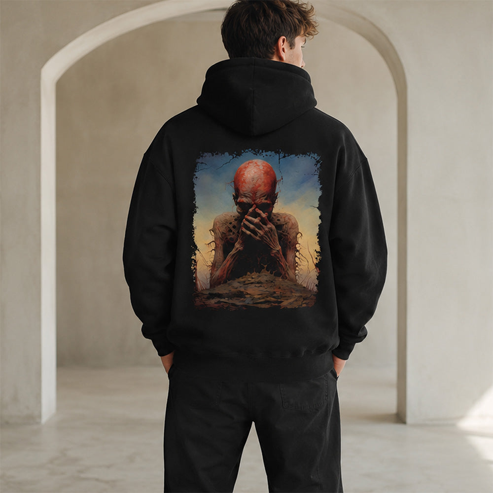 A man viewed from behind wearing a black hoodie with a large, detailed graphic print on the back showing a surreal scene of a bald figure with a red head covering his face. He is standing in a minimalist, light-colored stone corridor with arches.