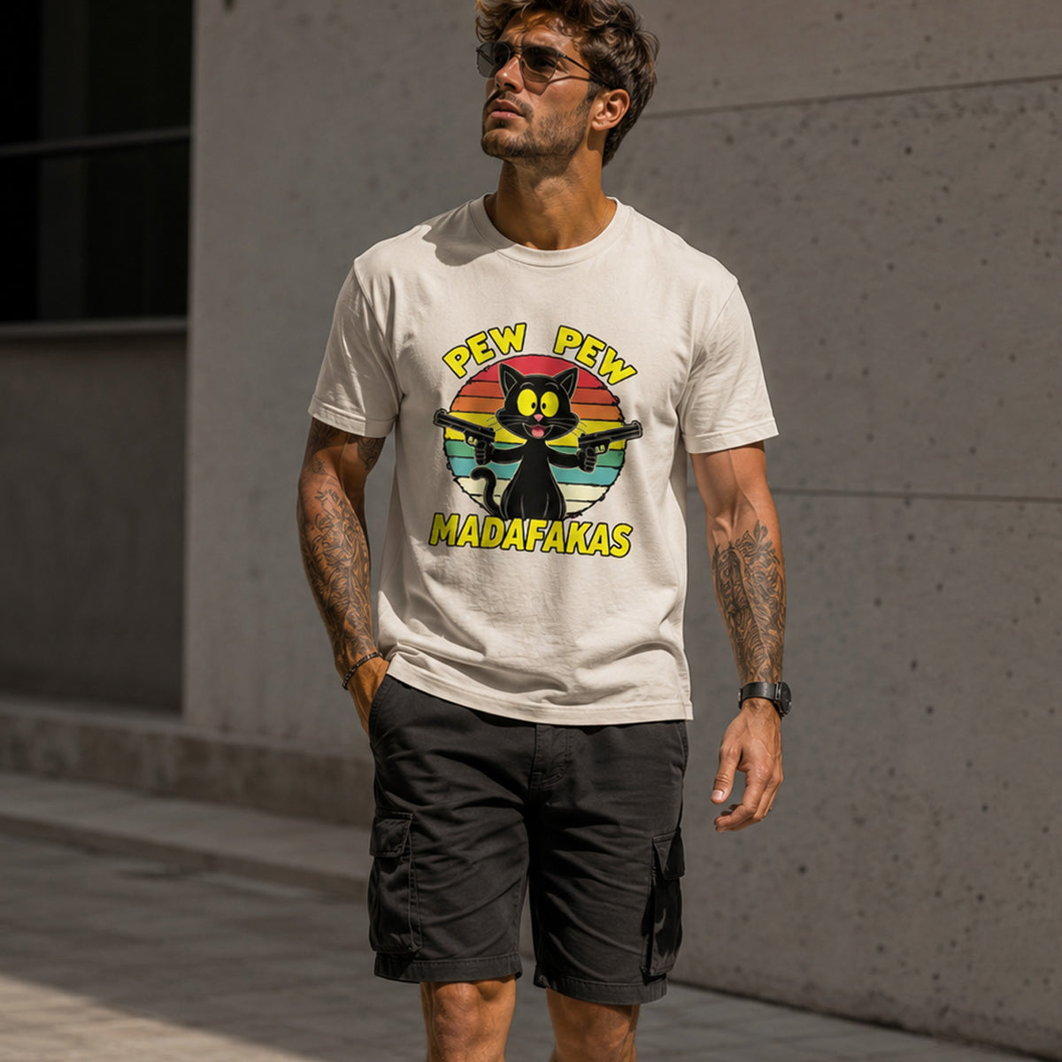 Man wearing a t-shirt with a graphic design and text, standing against a concrete wall.