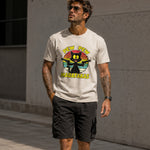 Man wearing a t-shirt with a graphic design and text, standing against a concrete wall.