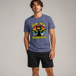 Man wearing a blue t-shirt with a colorful graphic and text against a plain background