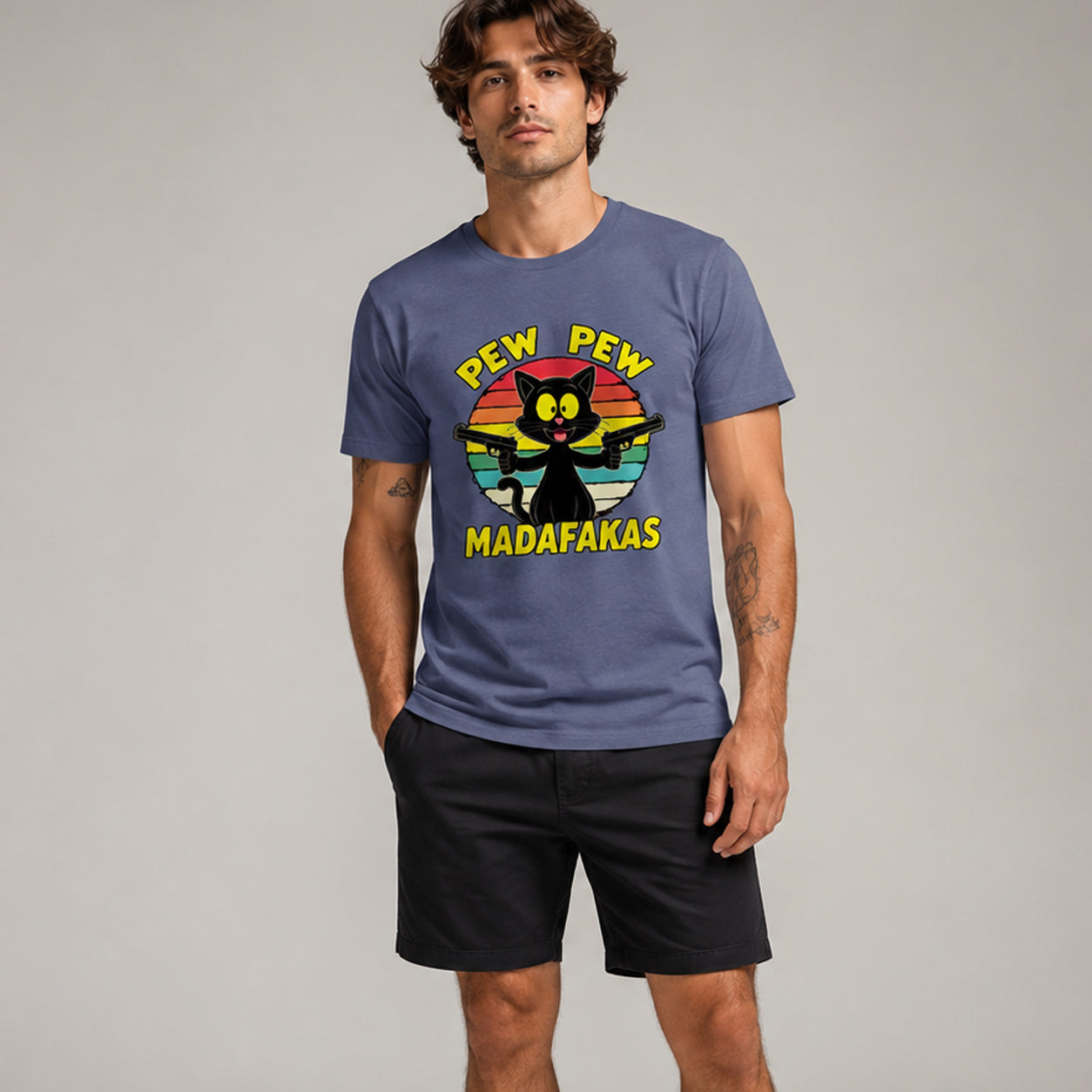 Man wearing a blue t-shirt with a colorful graphic and text against a plain background