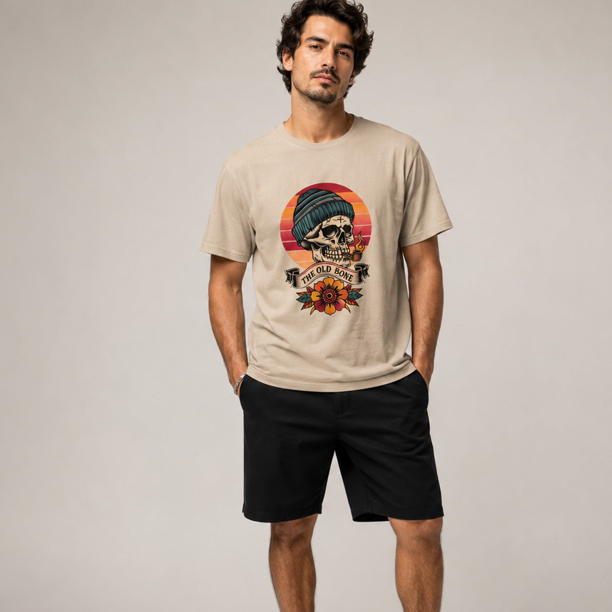 Man wearing a beige t-shirt with a graphic design on a plain background