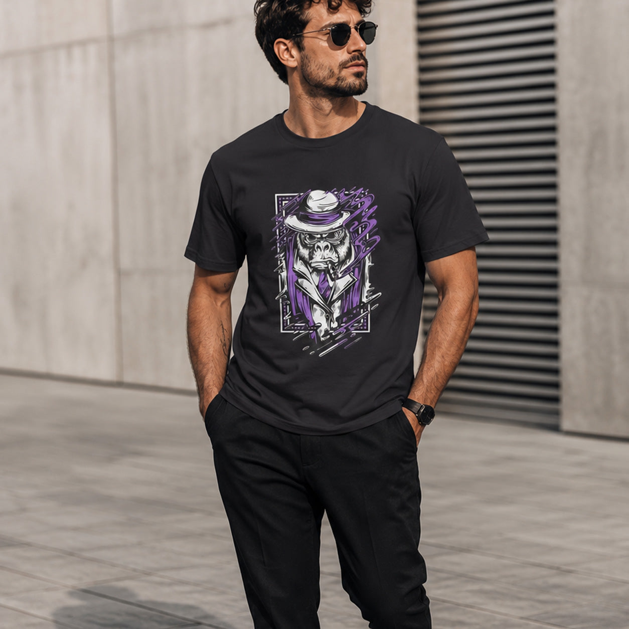 Man wearing a black t-shirt with a graphic design of a monkey in a suit and hat, standing against a neutral background.