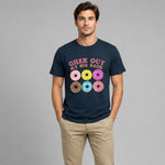 Man wearing a navy blue t-shirt with colorful donut graphics and text on a gray background