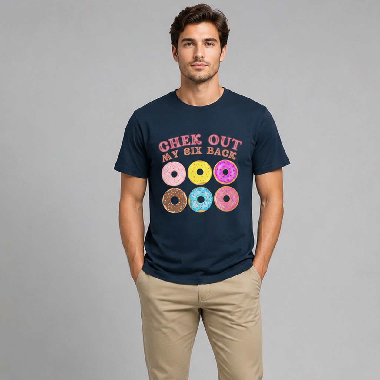 Man wearing a navy blue t-shirt with colorful donut graphics and text on a gray background