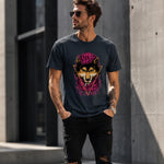 Man wearing a black t-shirt with a graphic design of a wolf and colorful elements, standing against a concrete wall.