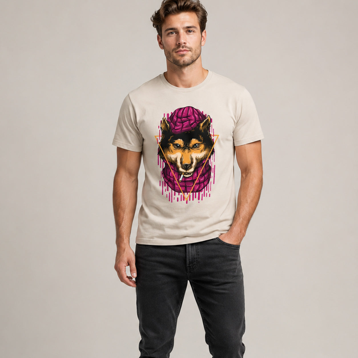 Man wearing a t-shirt with a graphic design of a dog wearing a purple hat on a plain background