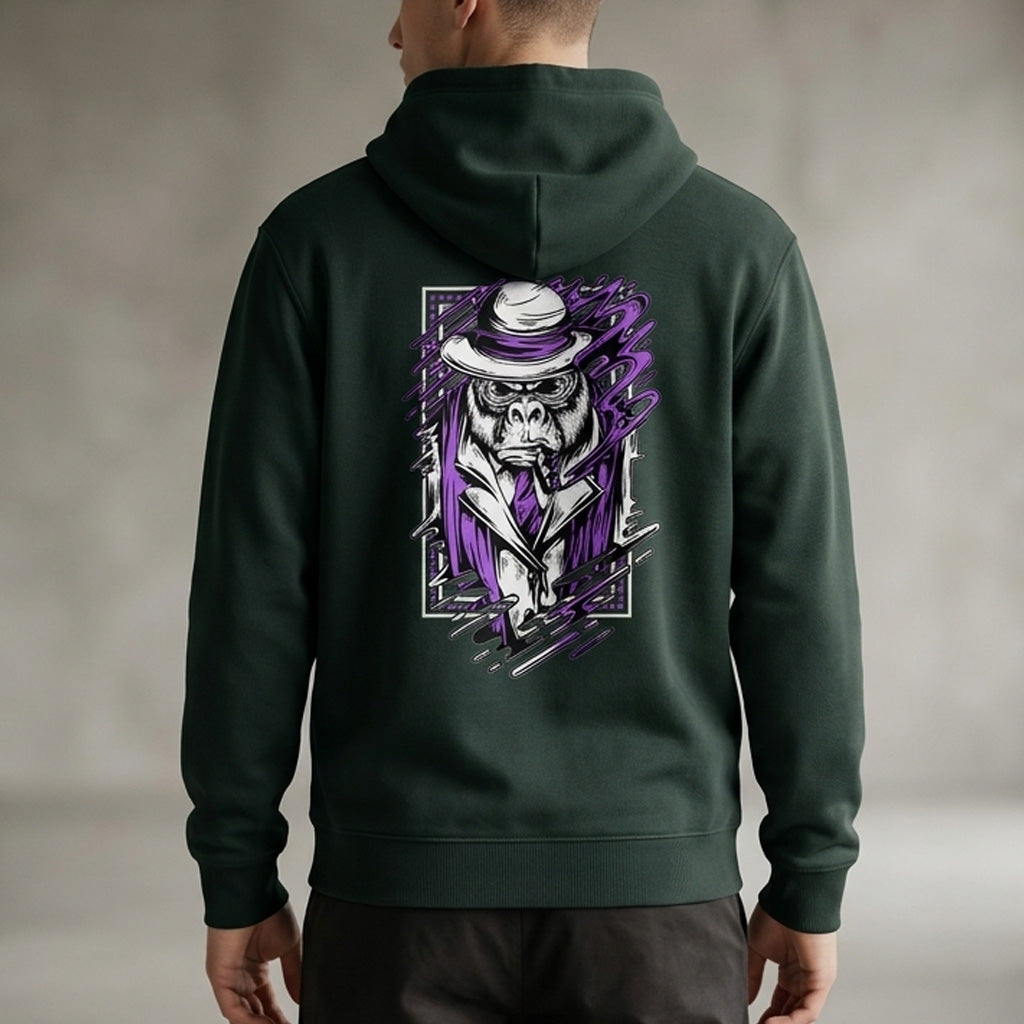 A man wearing a dark green hoodie with a graphic on the back of a gorilla dressed in a suit, tie, and hat, featuring purple and white accents in a bold, artistic style.