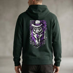 A man wearing a dark green hoodie with a graphic on the back of a gorilla dressed in a suit, tie, and hat, featuring purple and white accents in a bold, artistic style.
