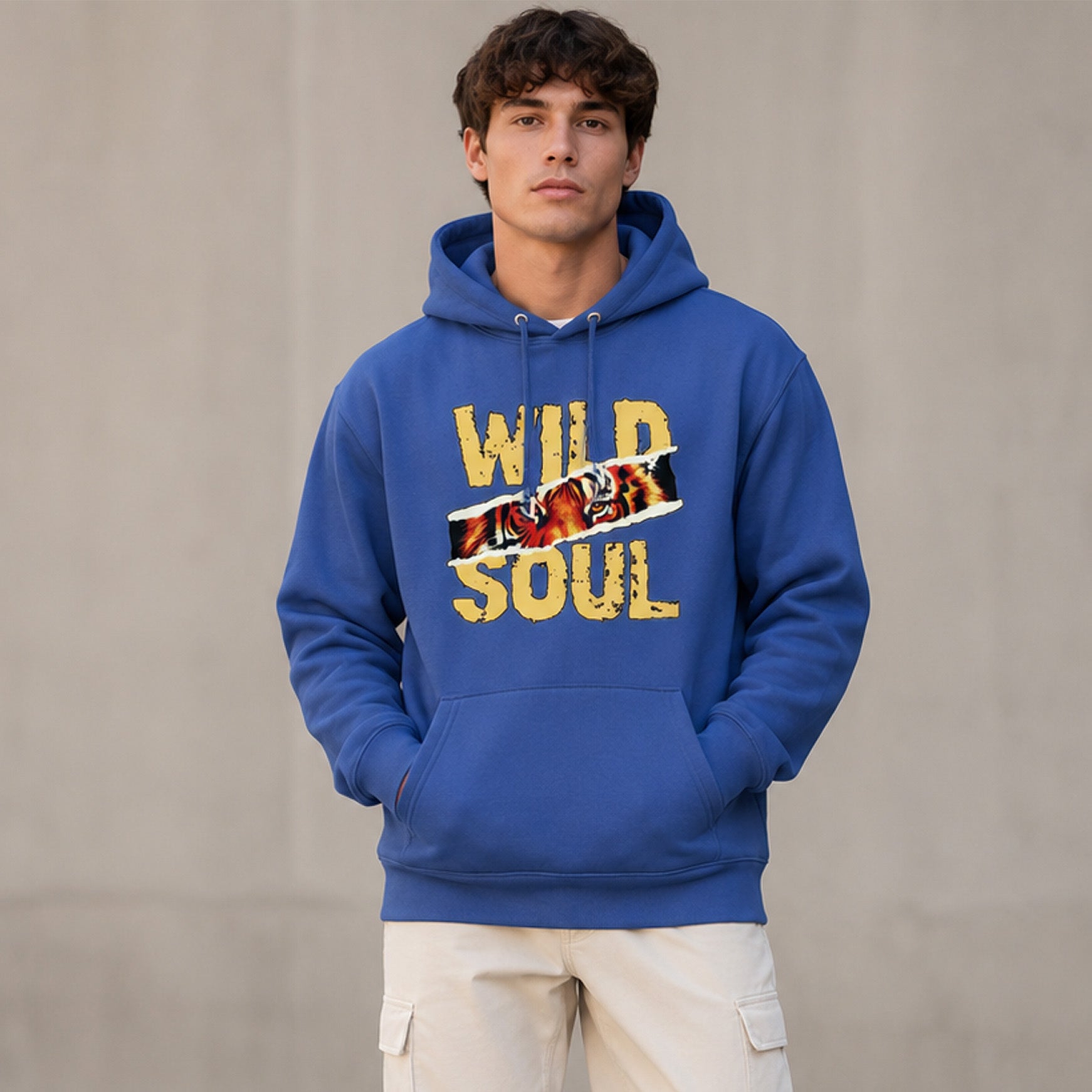 Man wearing a blue hoodie with 'Wild Soul' text and graphic on a plain background
