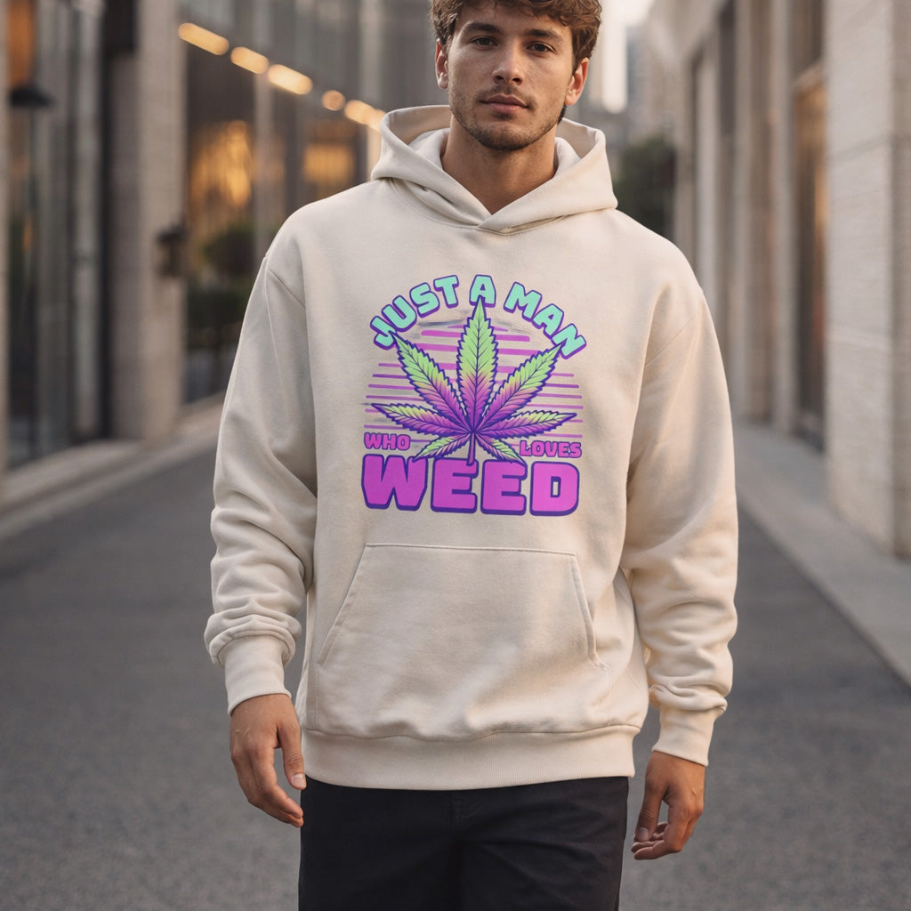 Man wearing a hoodie with a cannabis leaf design and text on a city street.