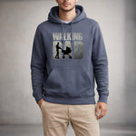 A man wearing a blue hoodie with the text "WALKING DAD" and a graphic of a man pushing a stroller. He is also wearing beige pants and standing against a neutral background.