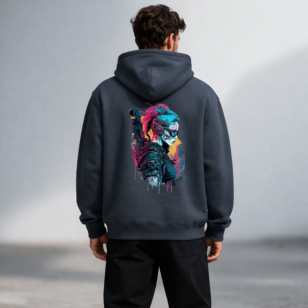 A man wearing a dark hoodie with a colorful graphic on the back depicting a futuristic, masked character with bright hair and cyberpunk elements. The man is standing outdoors, facing away from the camera.