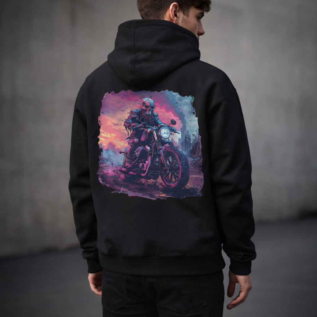 Man wearing a black hoodie with a colorful graphic of a person on a motorcycle on the back against a gray background.