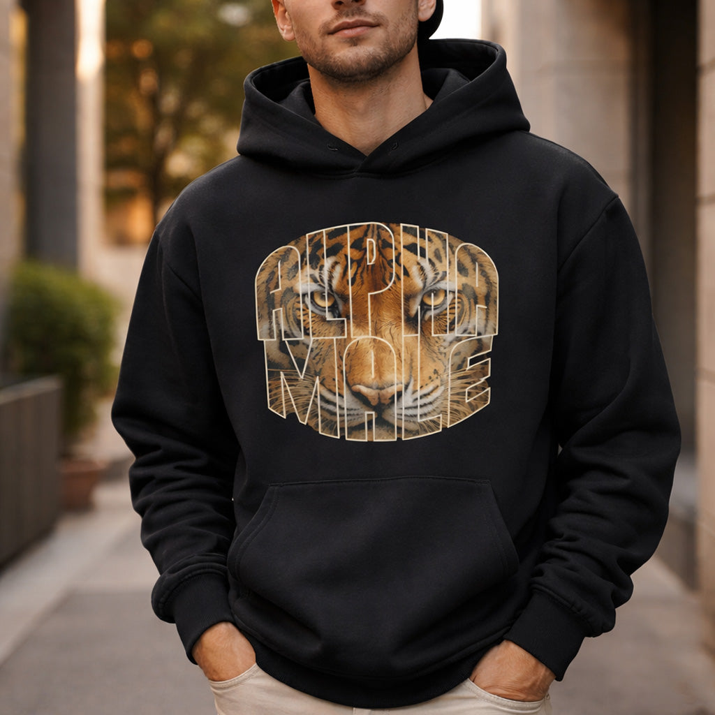 Man wearing a black hoodie with a tiger graphic and text outdoors.