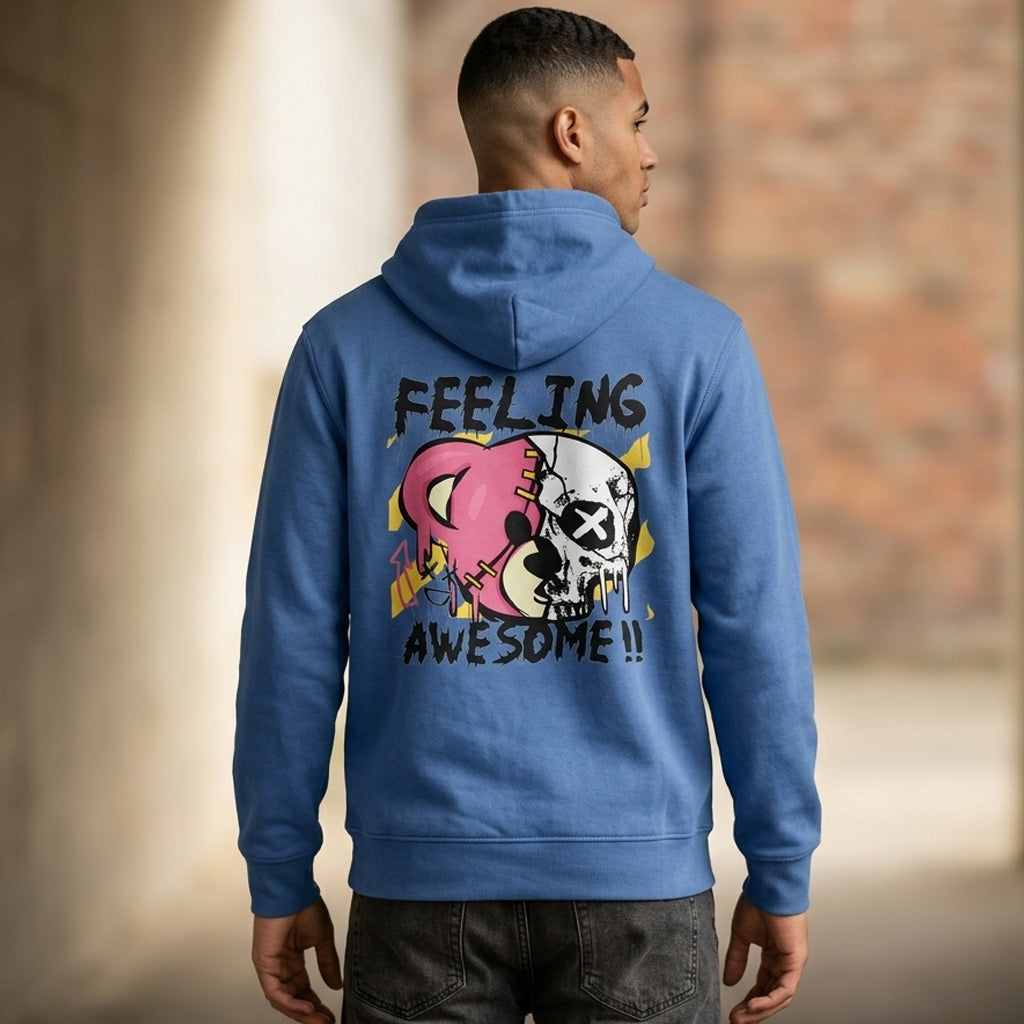 A man wearing a blue hoodie with a graphic of a pink bear and a white skull, plus the words "FEELING AWESOME!!" on the back, stands outdoors facing away from the camera.