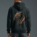 A person wearing a black hoodie with a large, detailed golden dragon head design on the back, facing away from the camera against a plain gray background.