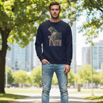 Man wearing a navy sweatshirt with a religious design and 'FAITH' text, standing outdoors with trees and buildings in the background.