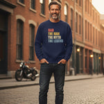 Man wearing a navy blue sweatshirt with colorful text in an urban setting