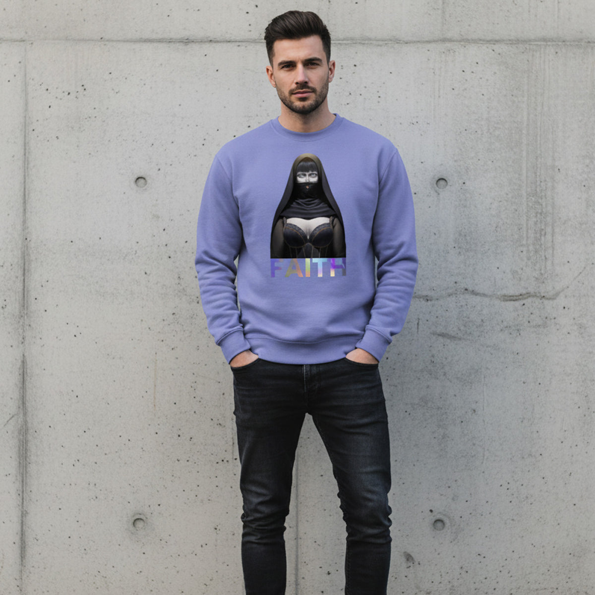 A man stands against a concrete wall, wearing a lavender sweatshirt featuring an illustrated nun in black robes and the word "FAITH" in bold letters beneath the image. He has dark hair and a trimmed beard.