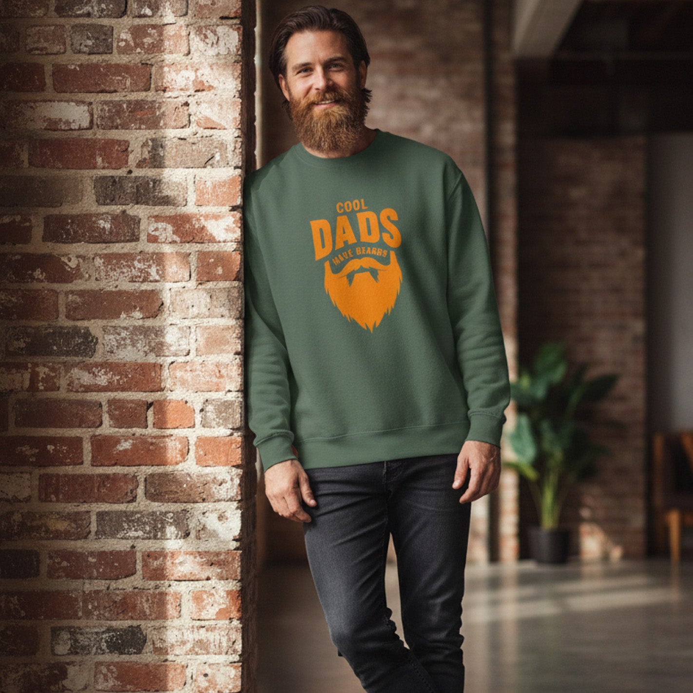 Man wearing a green sweatshirt with 'Cool Dads Make Beards' text and beard graphic against a brick wall.