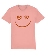 Women's Pink t-shirt with a smiley face design featuring heart eyes on a white background