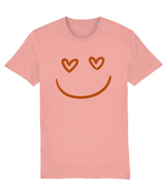 Women's Pink t-shirt with a smiley face design featuring heart eyes on a white background