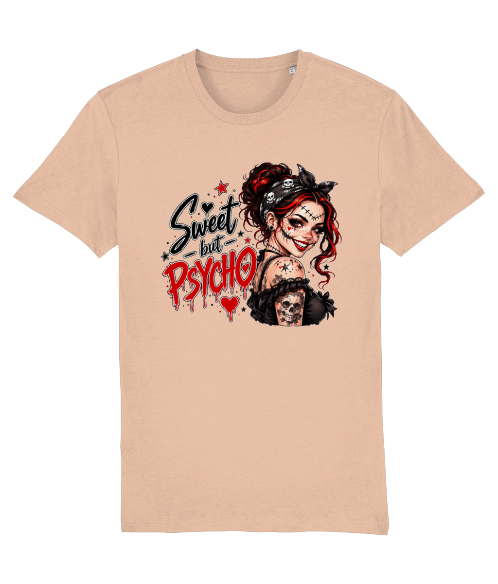 A light peach-beige short-sleeve womens t-shirt with a graphic print on the front. The graphic features a stylized illustration of a woman with red hair, a black bandana, and a skull, alongside the text 'Sweet but PSYCHO' in black and red lettering.