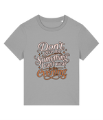 A gray short-sleeve crewneck womens t-shirt featuring a decorative graphic text print on the front that reads 'Don't give me Something I can't wear in the Evening' in pink, white, and orange lettering with small star accents.