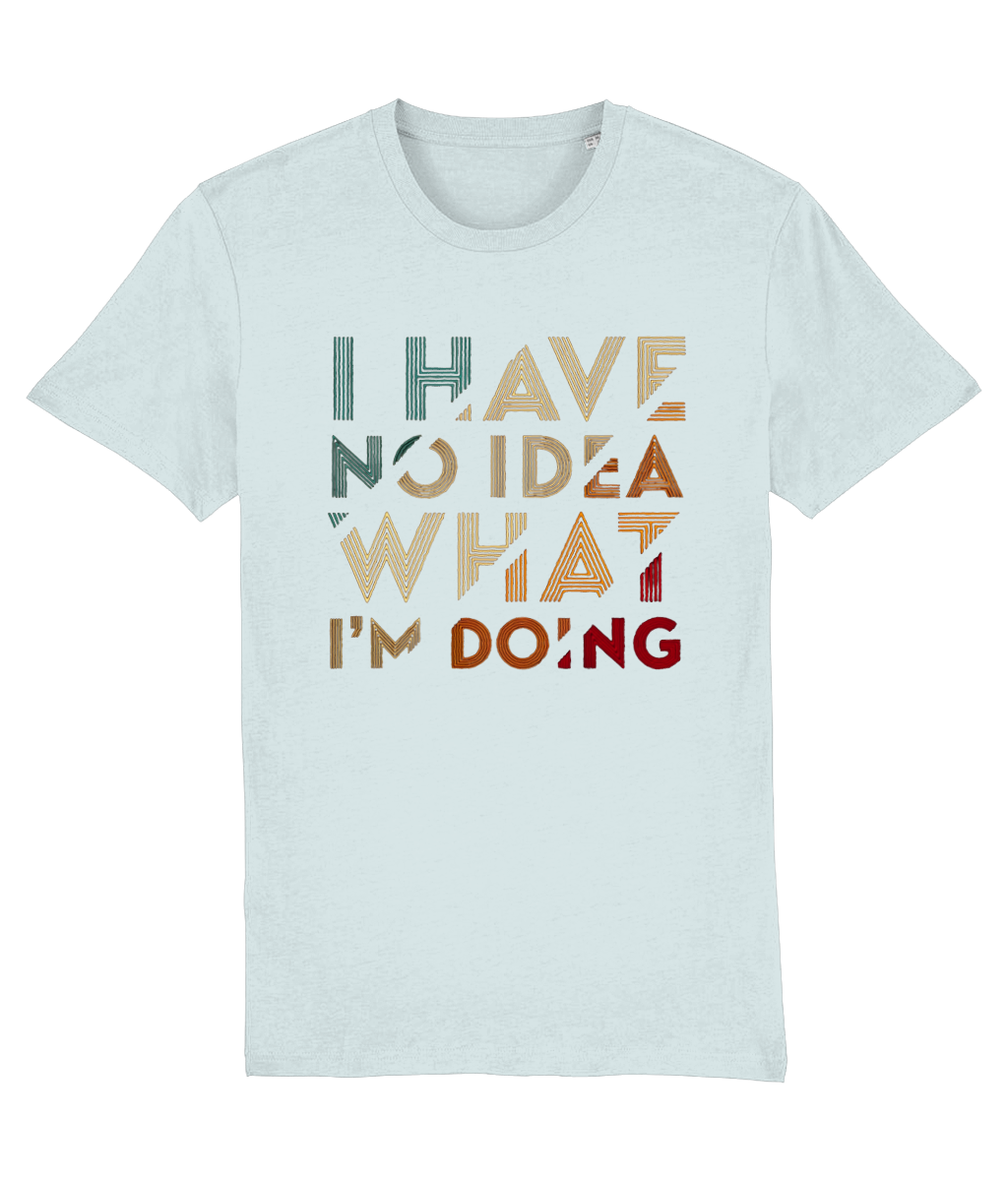 A light blue-gray womens crewneck t-shirt featuring a retro-style typographic graphic on the chest that reads 'I HAVE NO IDEA WHAT I'M DOING' in stacked, distressed letters of varying colors including teal, beige, orange, and red.