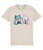 A womens Stanley/Stella light beige crewneck t-shirt featuring a graphic print of two chibi anime characters, one with teal hair and one with white hair, facing each other with a small pink heart above them.